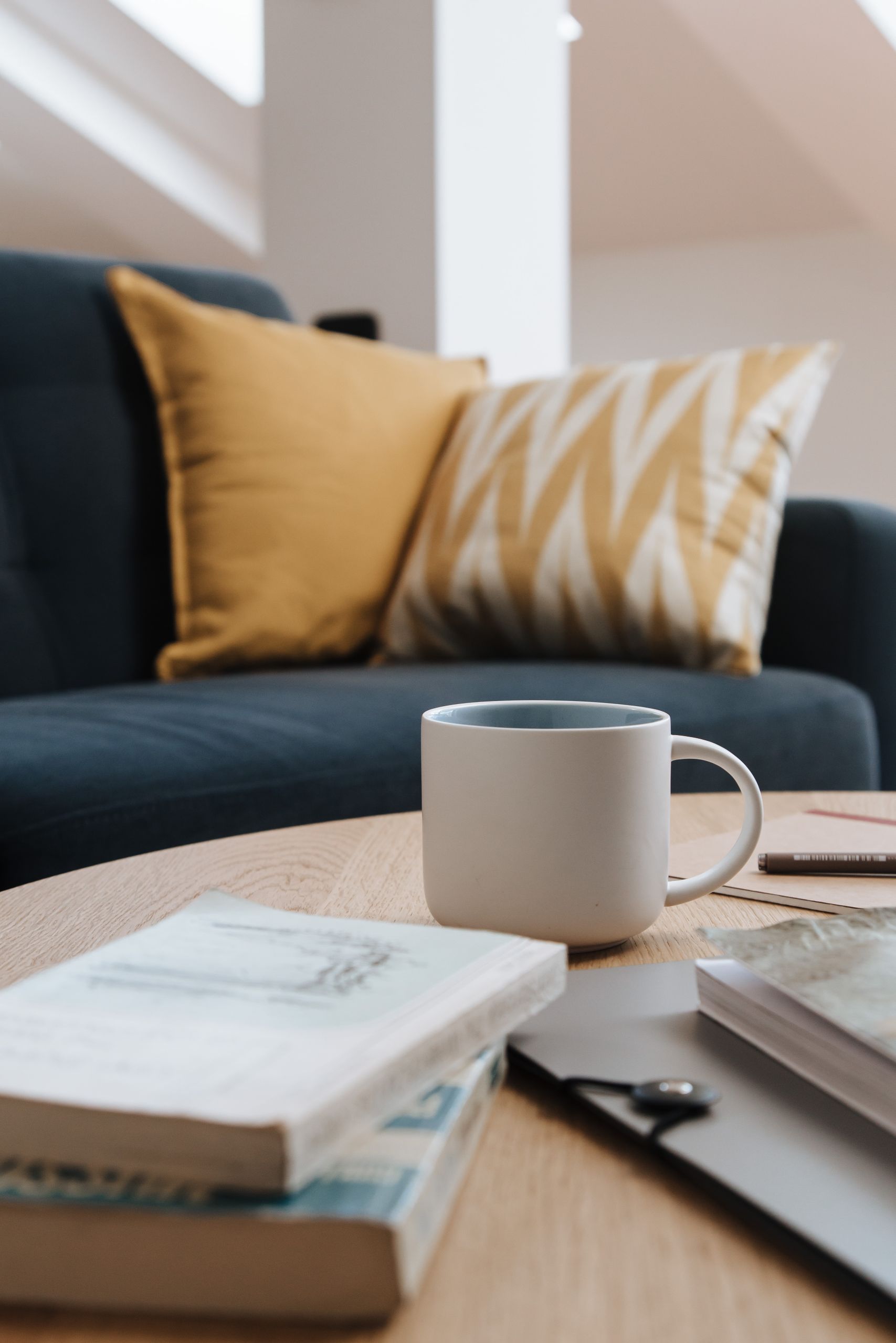 Inviting living space featuring a coffee cup and books on a wooden table.